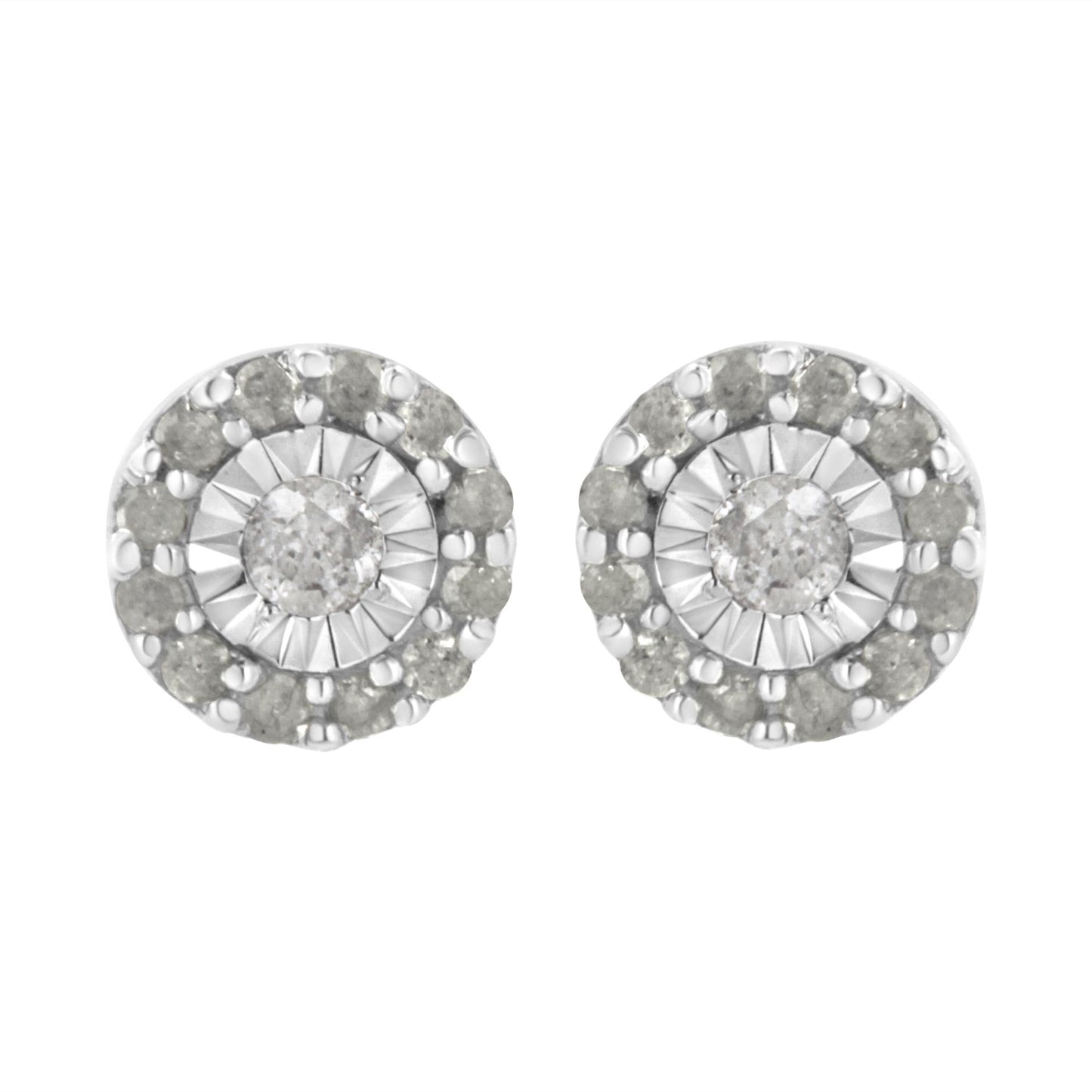 Front view of a pair of white metal round stud earrings featuring a central white gemstone in miracle setting, surrounded by a circle of smaller white gemstones in shared prong setting.