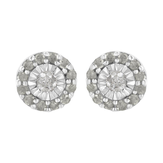 Front view of a pair of white metal round stud earrings featuring a central white gemstone in miracle setting, surrounded by a circle of smaller white gemstones in shared prong setting.