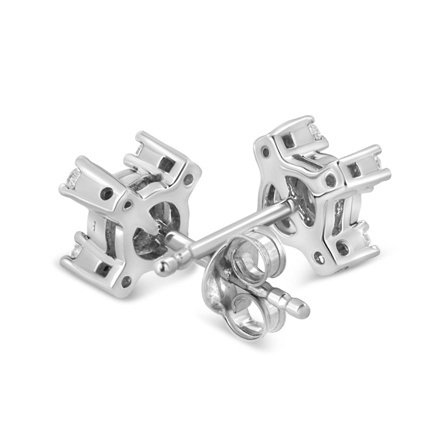 Close-up angled view of white metal stud earrings with round white gemstones in miracle and prong settings.