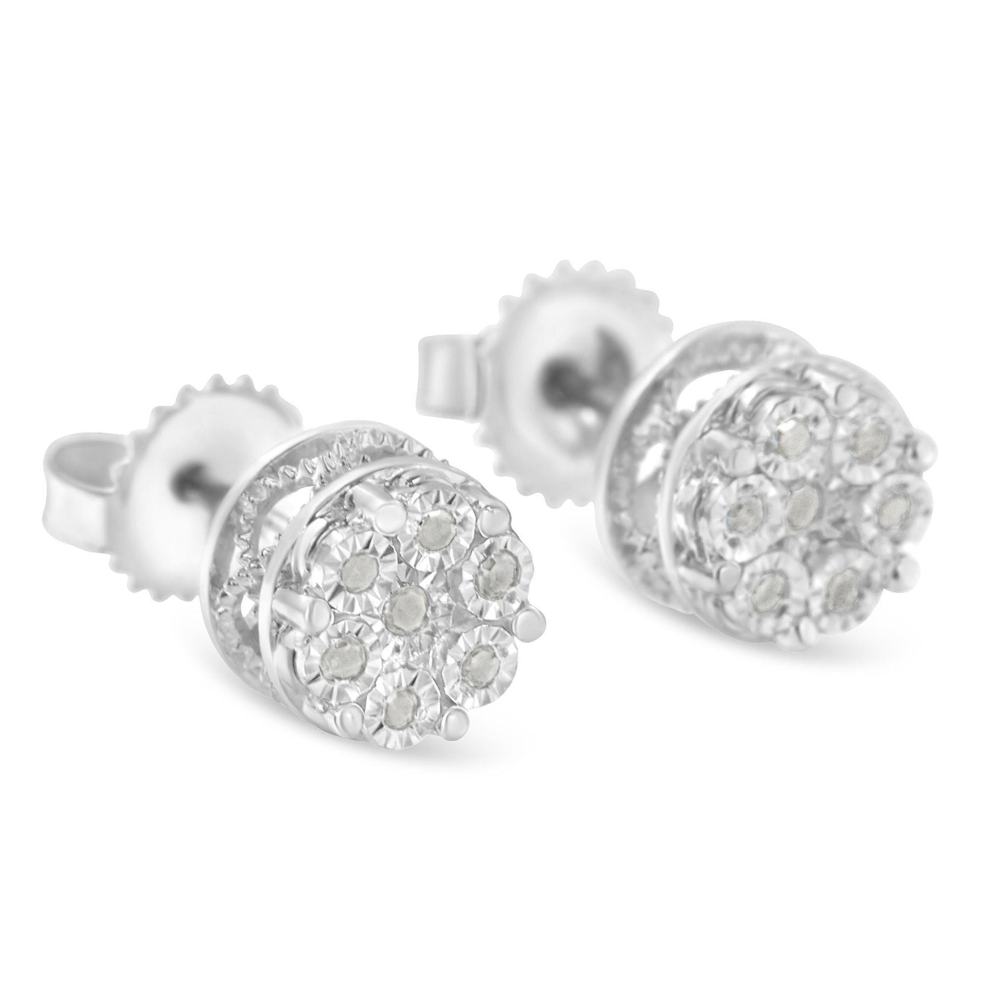 Close-up front angle of a pair of white metal stud earrings with clusters of round white gemstones in a circular miracle setting.