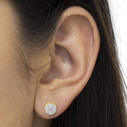 Close-up side view of a yellow metal round stud earring with multiple white gemstones, worn on a model's ear.