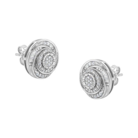 Front angled view of white metal circular stud earrings featuring concentric swirl design with round and baguette white gemstones in prong and channel settings.