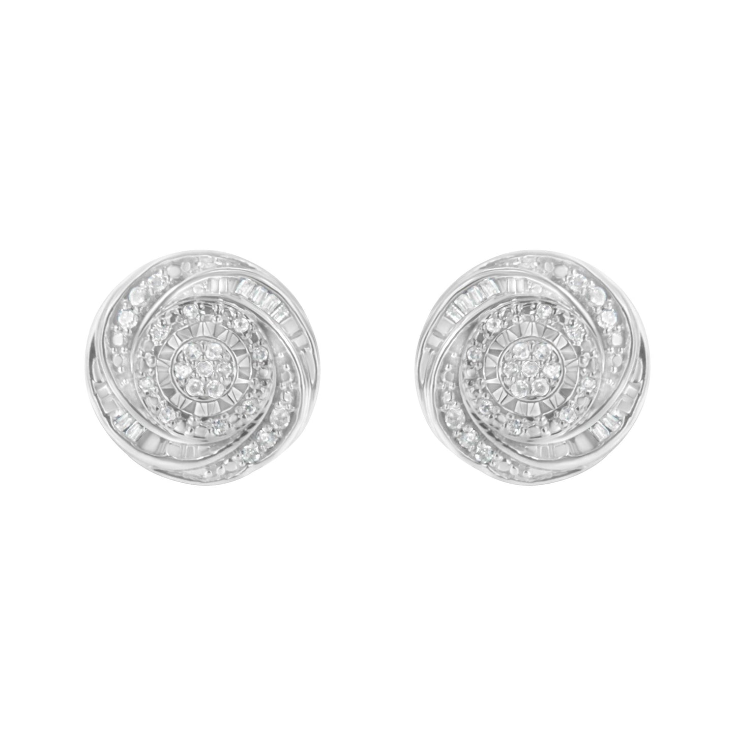 Front view of a pair of white metal round earrings with swirling patterns set with white round and baguette gemstones.