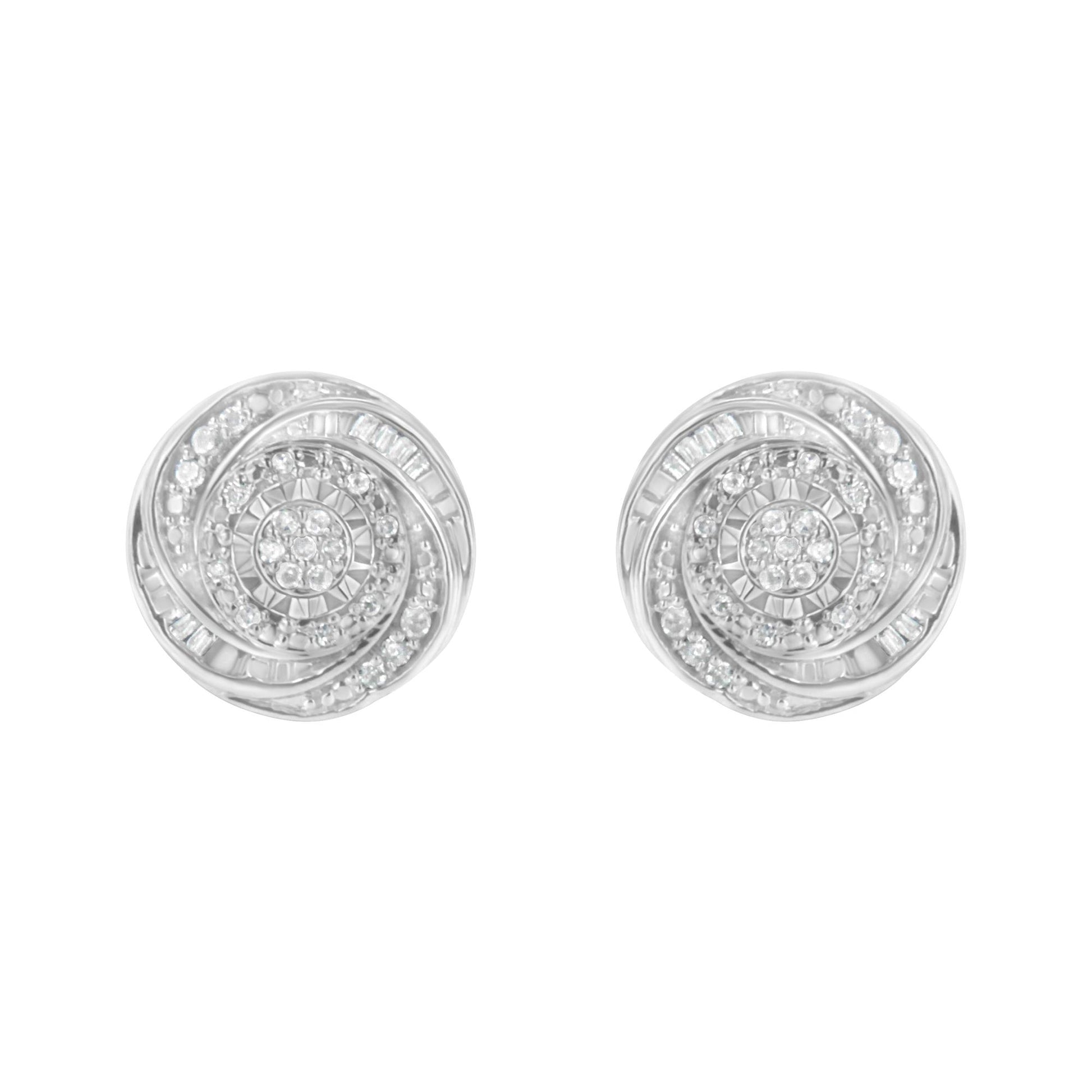 Front view of a pair of white metal round earrings with swirling patterns set with white round and baguette gemstones.