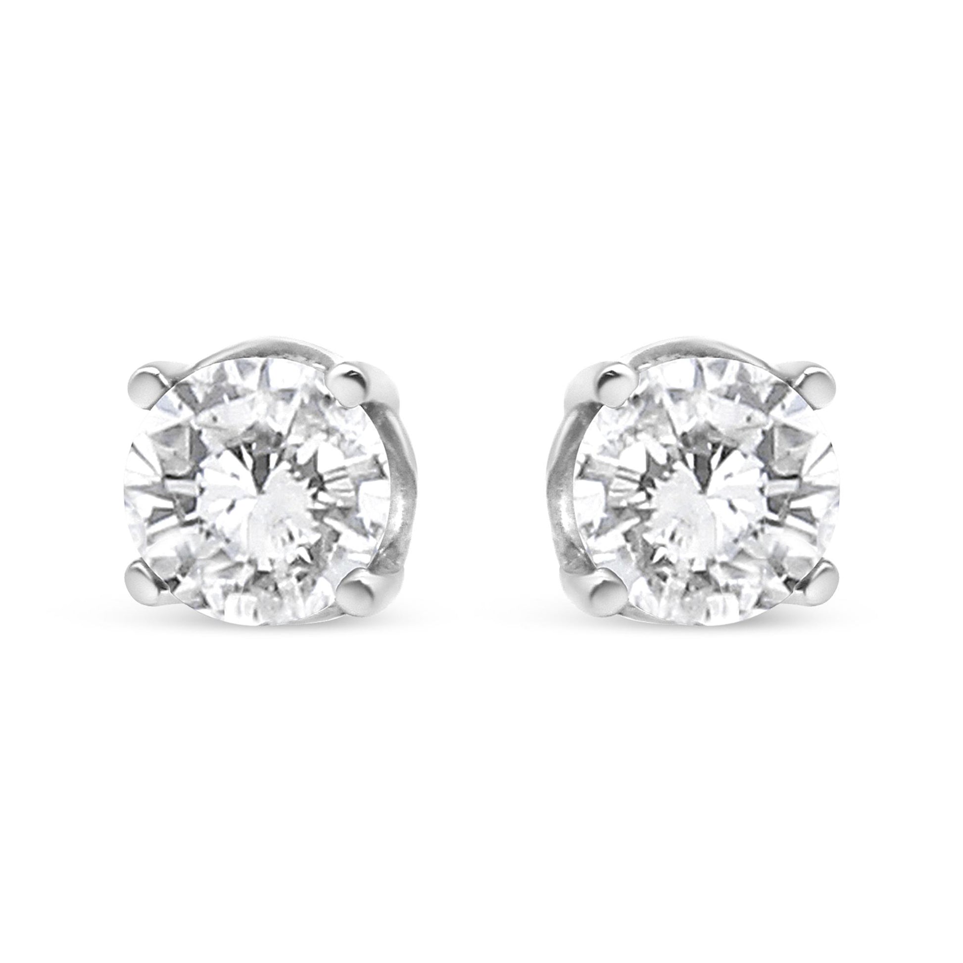 Front view of a pair of white metal stud earrings featuring round white gemstones in a four-prong setting.