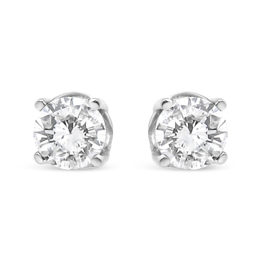 Front view of a pair of white metal stud earrings featuring round white gemstones in a four-prong setting.
