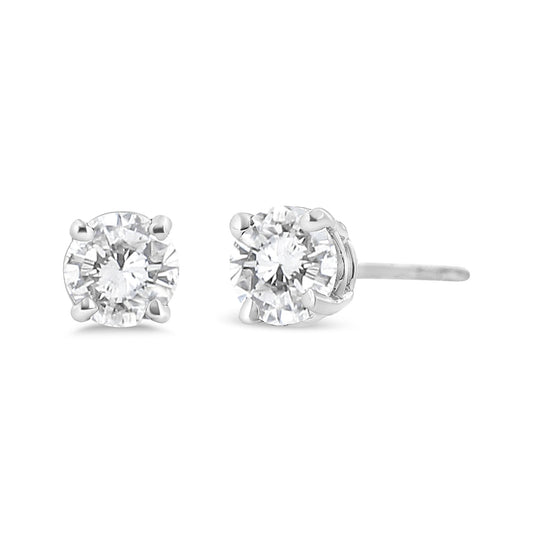 Close-up front and side angle of white metal stud earrings with round white gemstones set in four-prong settings.