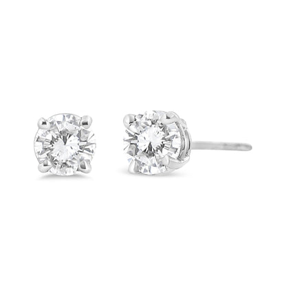 Close-up front and side angle of white metal stud earrings with round white gemstones set in four-prong settings.