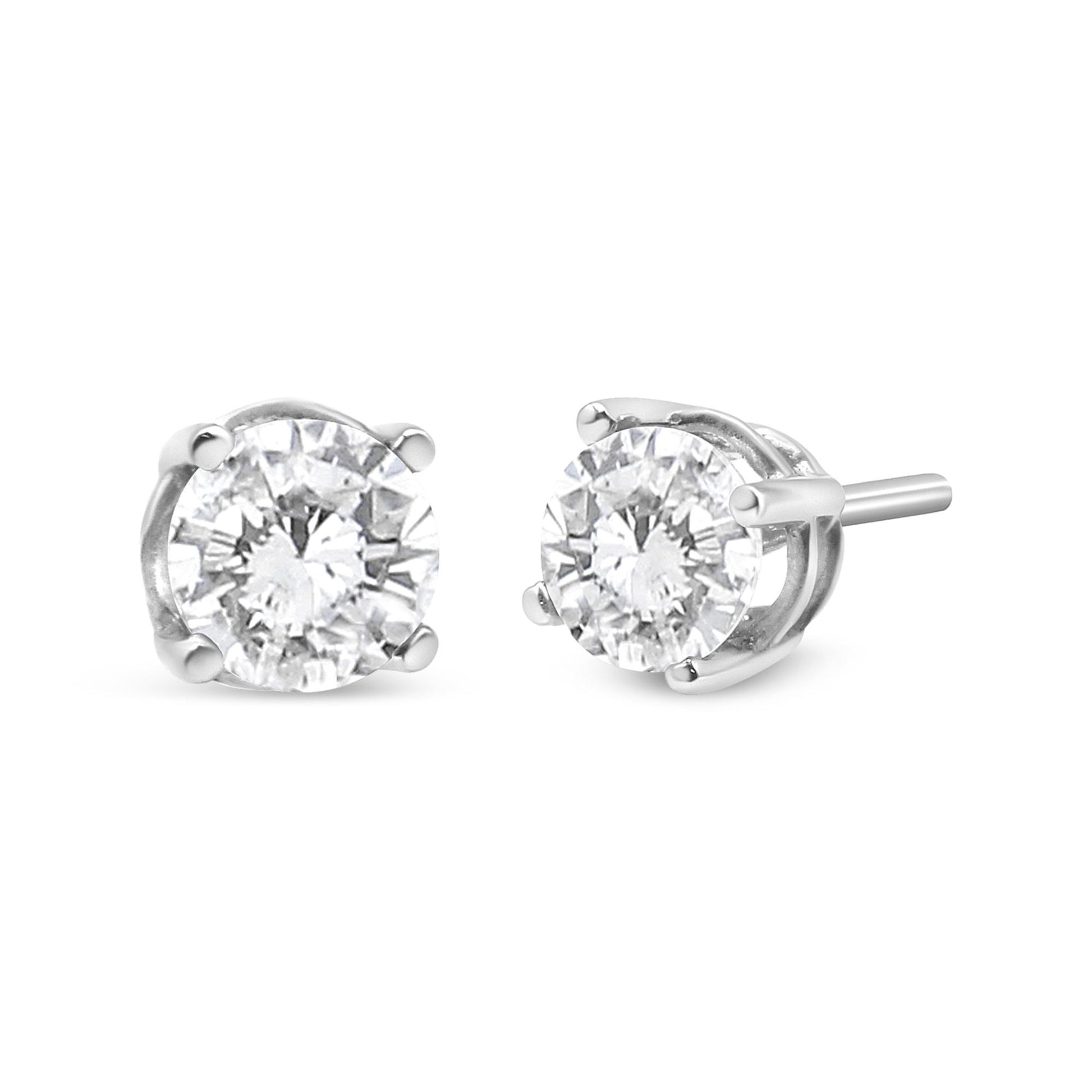 Pair of white metal stud earrings with round white gemstones in four-prong settings, shown from a front and side angle.