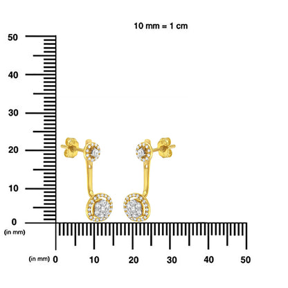 Pair of yellow metal drop earrings with white round gemstones in prong settings, displayed on a scale, front angle.