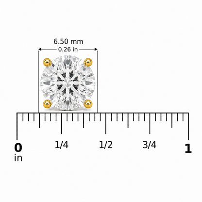 Close-up front view of a single yellow stud earring with a round white gemstone in a 4-prong setting, shown on a scale.