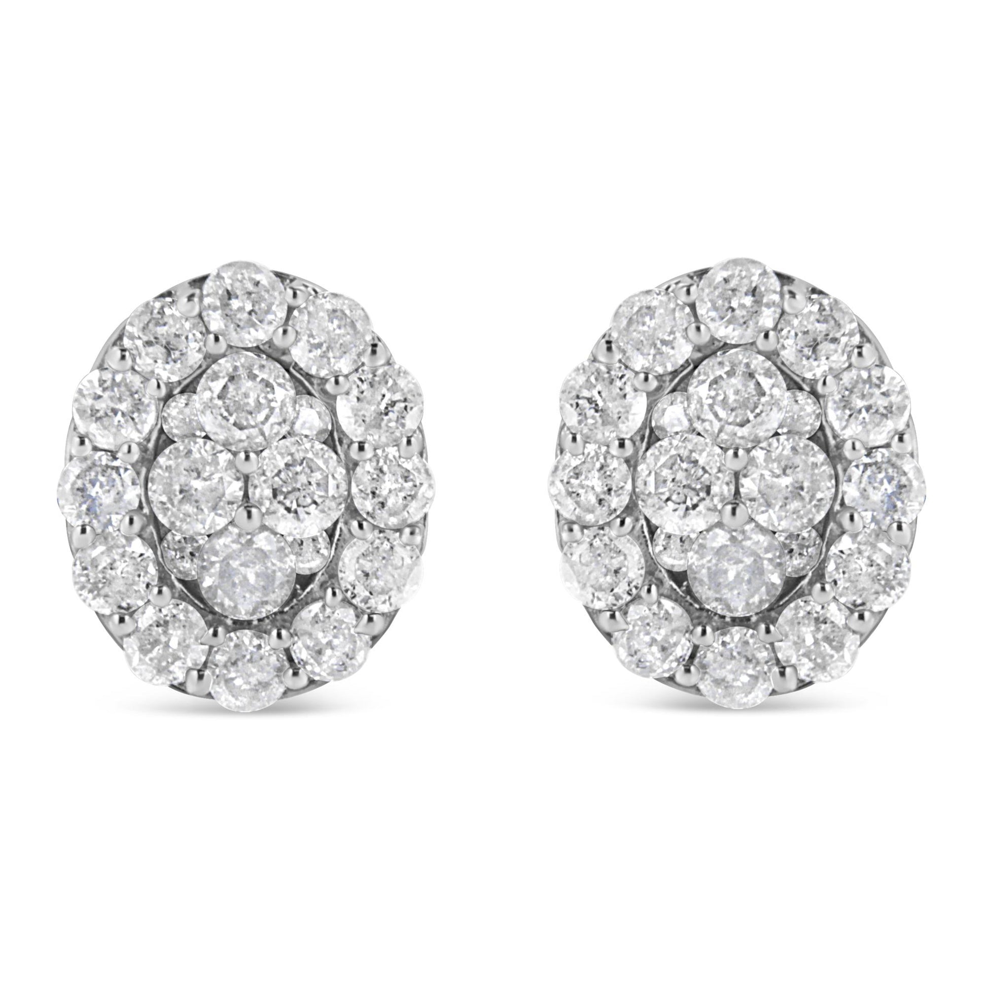 Front view of a pair of white metal stud earrings with round white gemstones in prong settings arranged in a cluster design.