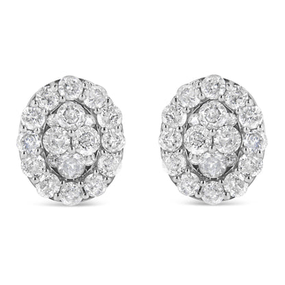 Front view of a pair of white metal stud earrings with round white gemstones in prong settings arranged in a cluster design.