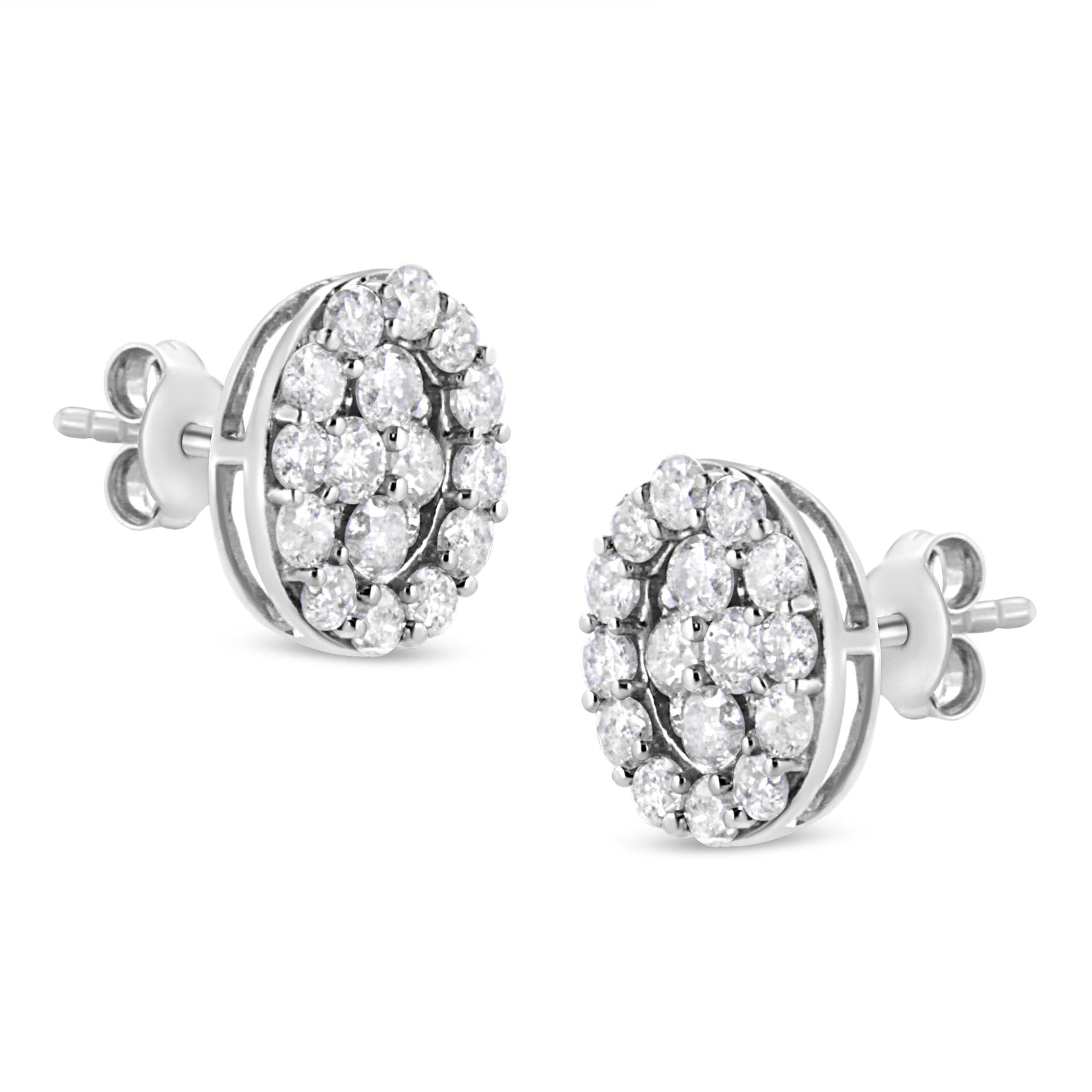 Pair of white metal round stud earrings with prong-set white gemstones, shown from a slight side angle.