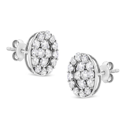 Pair of white metal round stud earrings with prong-set white gemstones, shown from a slight side angle.