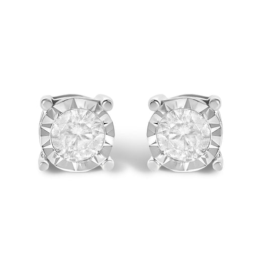 Pair of white stud earrings with round white gemstones in miracle settings, shown in a close-up, angled view.