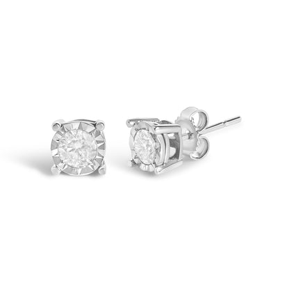 Pair of white metal stud earrings with round white gemstones in a miracle setting, shown from front and side angles.