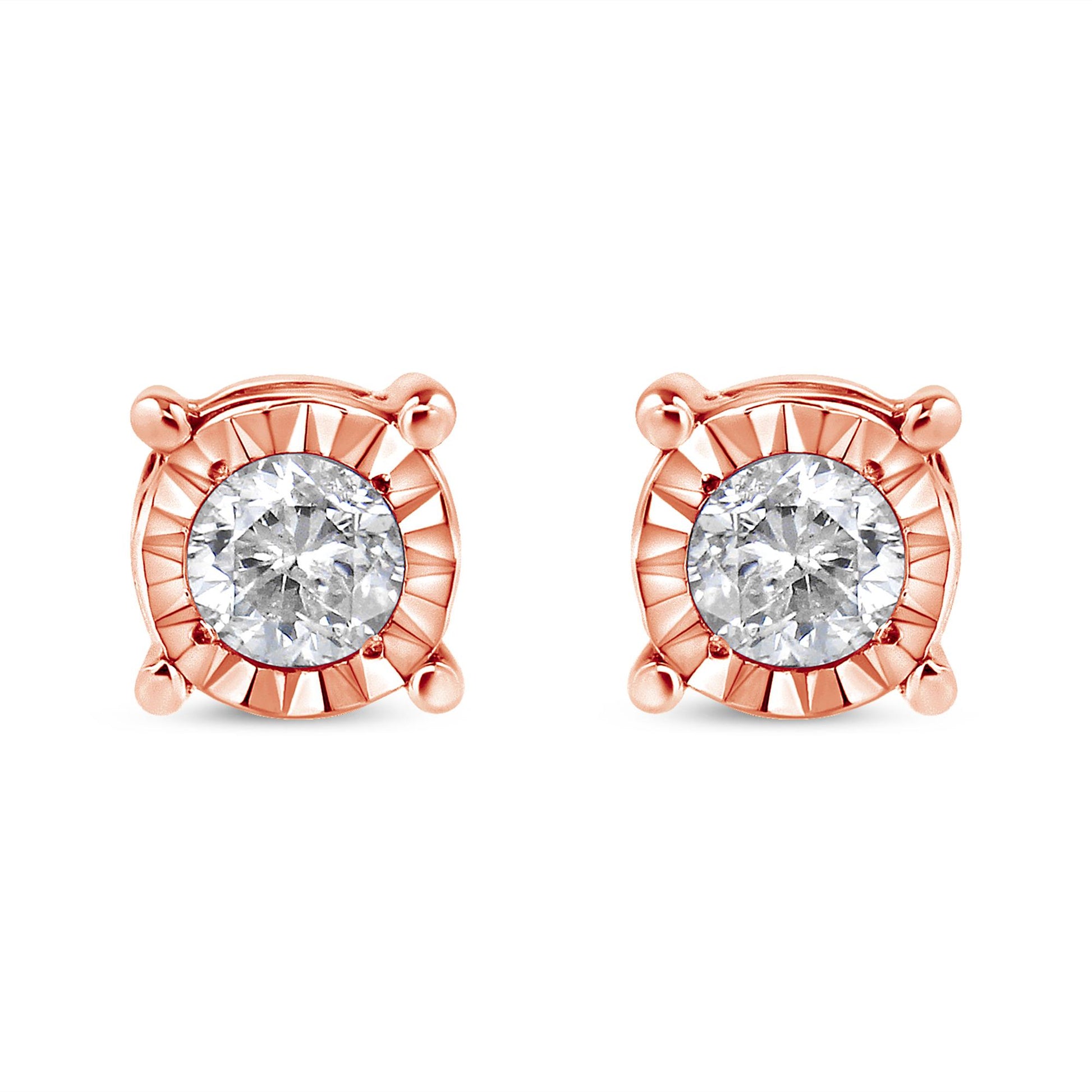 Front view of a pair of rose metal stud earrings each featuring a round white gemstone with a miracle setting.