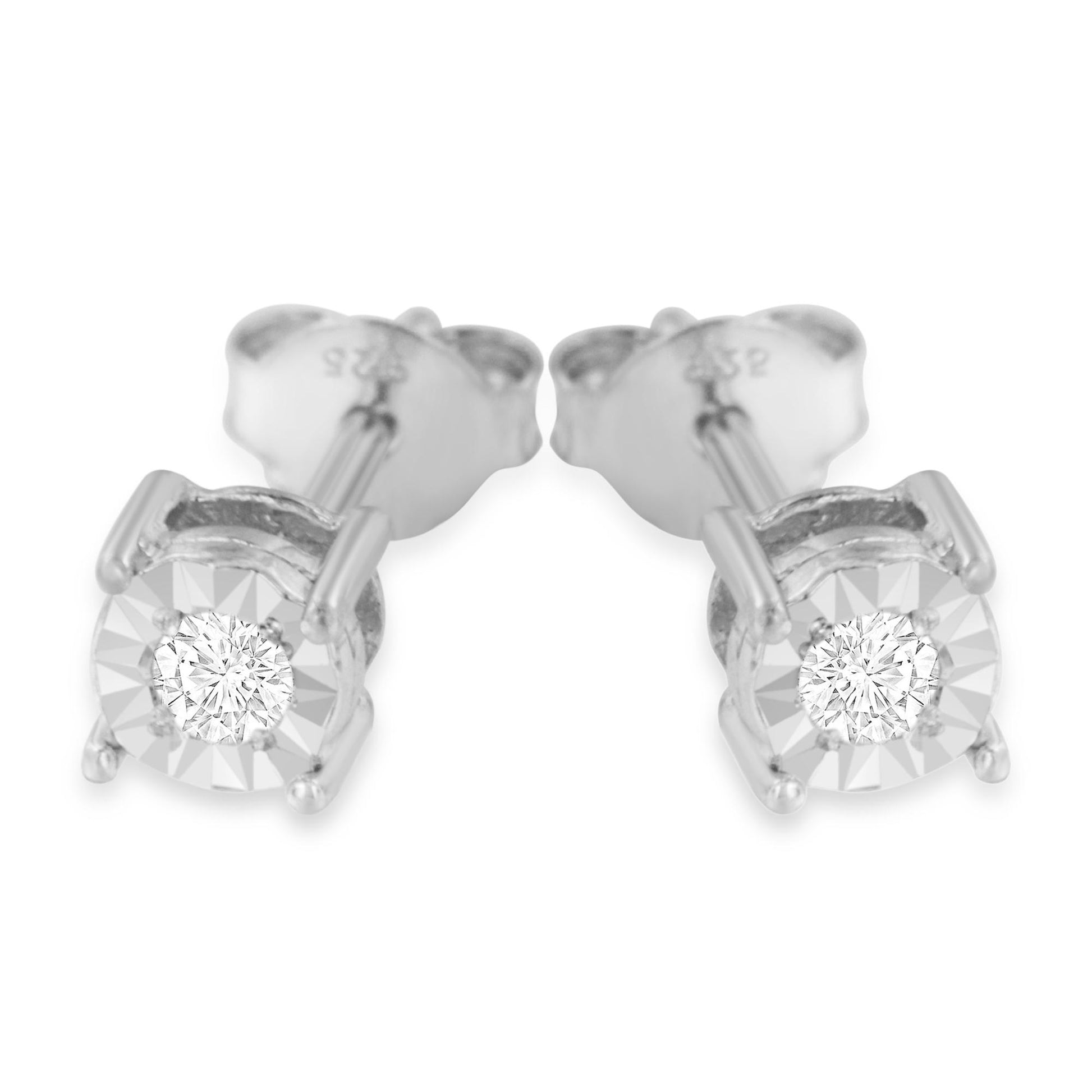 Close-up front view of a pair of white metal stud earrings featuring round white gemstones in a miracle setting.