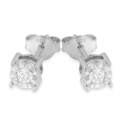 Close-up front view of a pair of white metal stud earrings featuring round white gemstones in a miracle setting.