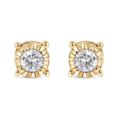 Front view of a pair of yellow metal stud earrings with round white gemstones in miracle settings.