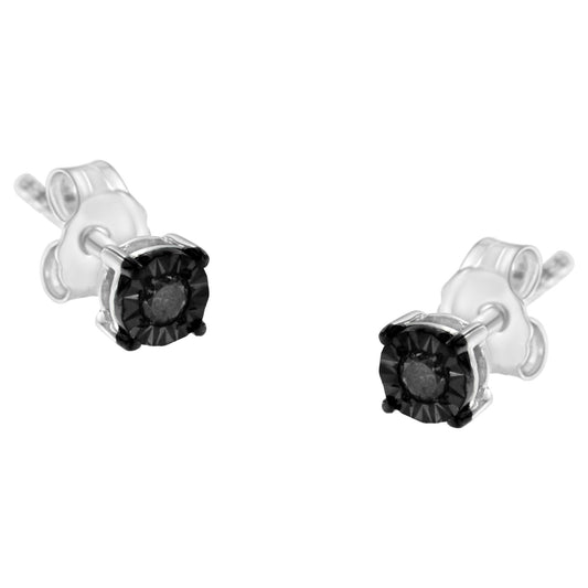 Close-up front angle of white and black stud earrings with round black gemstones in miracle settings.