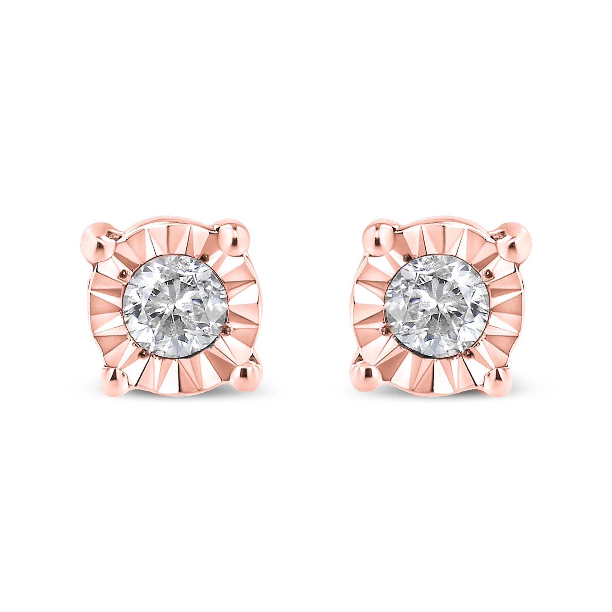Pair of rose metal stud earrings with round white gemstones in miracle setting, front view on white background.