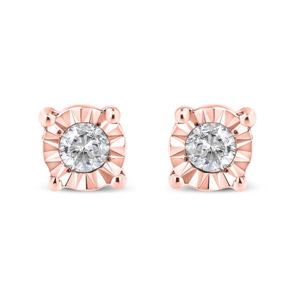 Pair of rose metal stud earrings with round white gemstones in miracle setting, front view on white background.