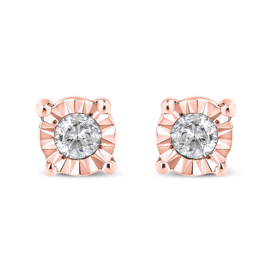 Pair of rose metal stud earrings with round white gemstones in miracle setting, front view on white background.