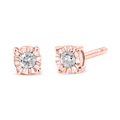 Close-up front and side angle view of rose metal stud earrings featuring round white gemstones in miracle settings.