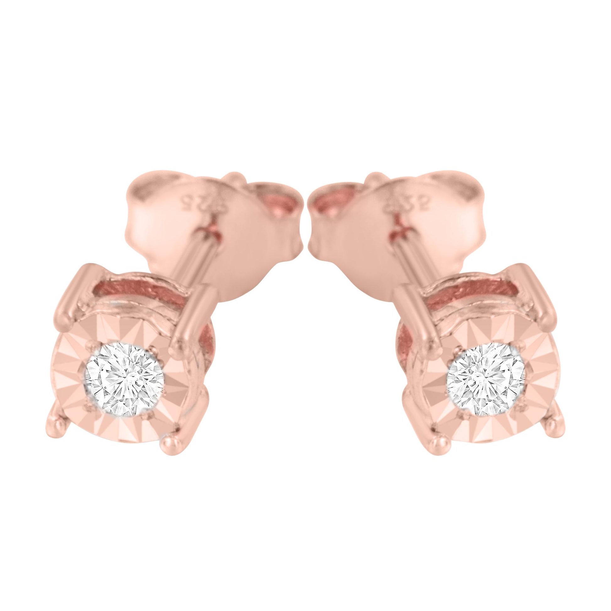 Close-up front view of a pair of rose metal stud earrings with round white gemstones in a miracle setting.