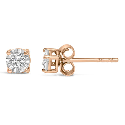 Close-up front and side view of a pair of rose metal stud earrings with round white gemstones in miracle settings.