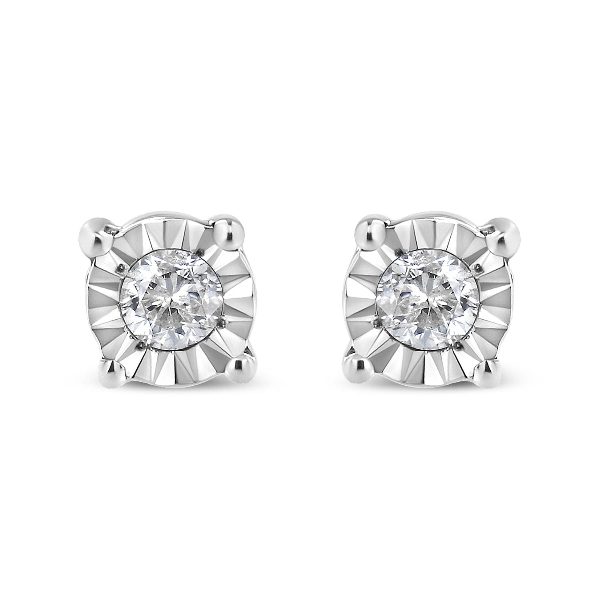 Front-facing view of a pair of white metal stud earrings, each featuring a round white gemstone in a miracle setting with polished prongs.