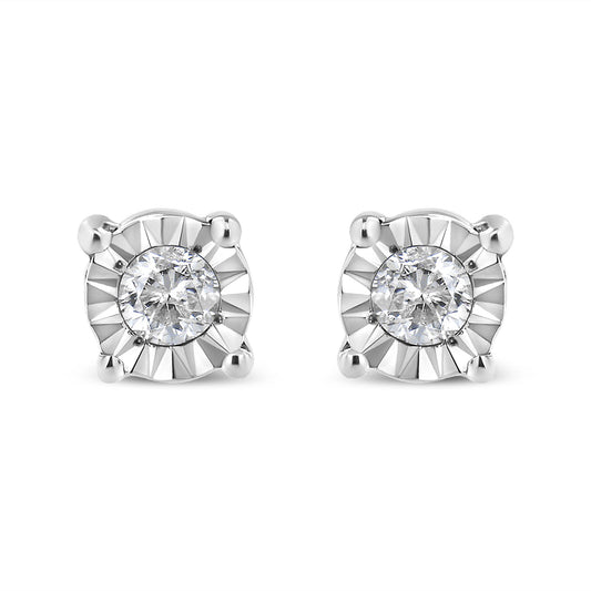 Front-facing view of a pair of white metal stud earrings, each featuring a round white gemstone in a miracle setting with polished prongs.