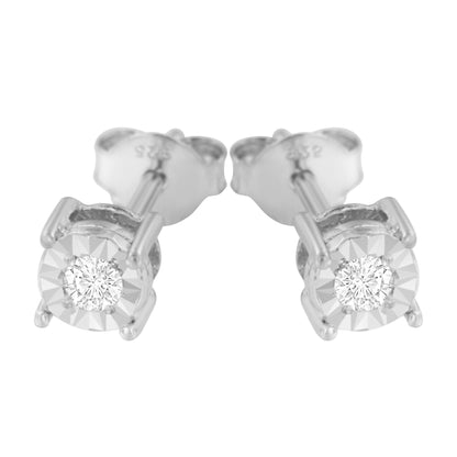 Close-up front angle of white metal stud earrings featuring round white gemstones in miracle settings.