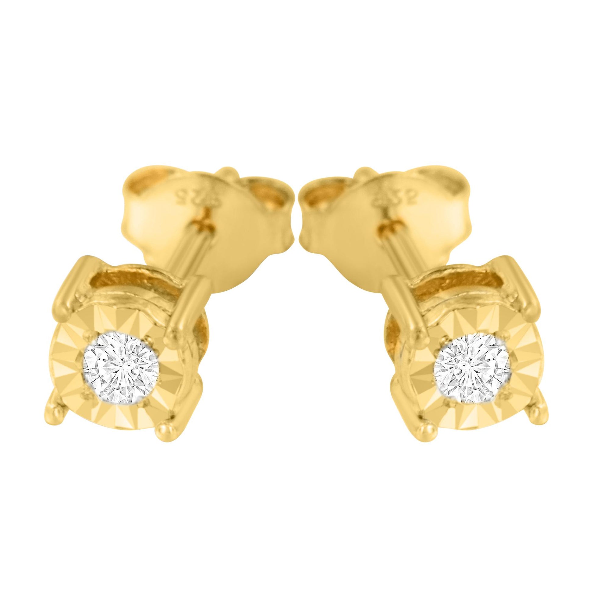 Close-up front angle of a pair of yellow metal stud earrings, each featuring a round white gemstone in mircale setting.