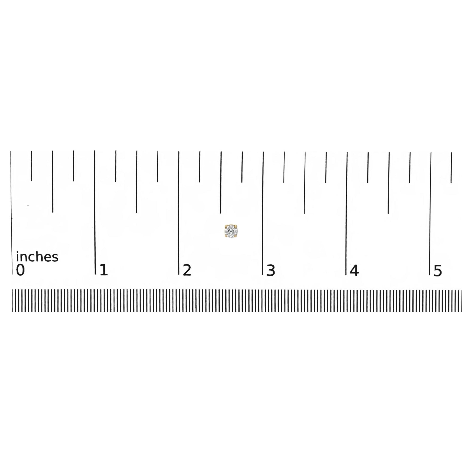 Close-up shot of a yellow metal round-shaped earring with two white gemstones in miracle setting, shown on a ruler for size reference.