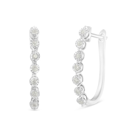 Front and side view of white metal hoop earrings with round white gemstones in miracle setting.