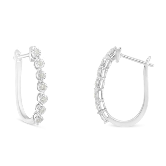 Pair of white metal hoop earrings with round white gemstones in miracle settings, shown from front and back angles.