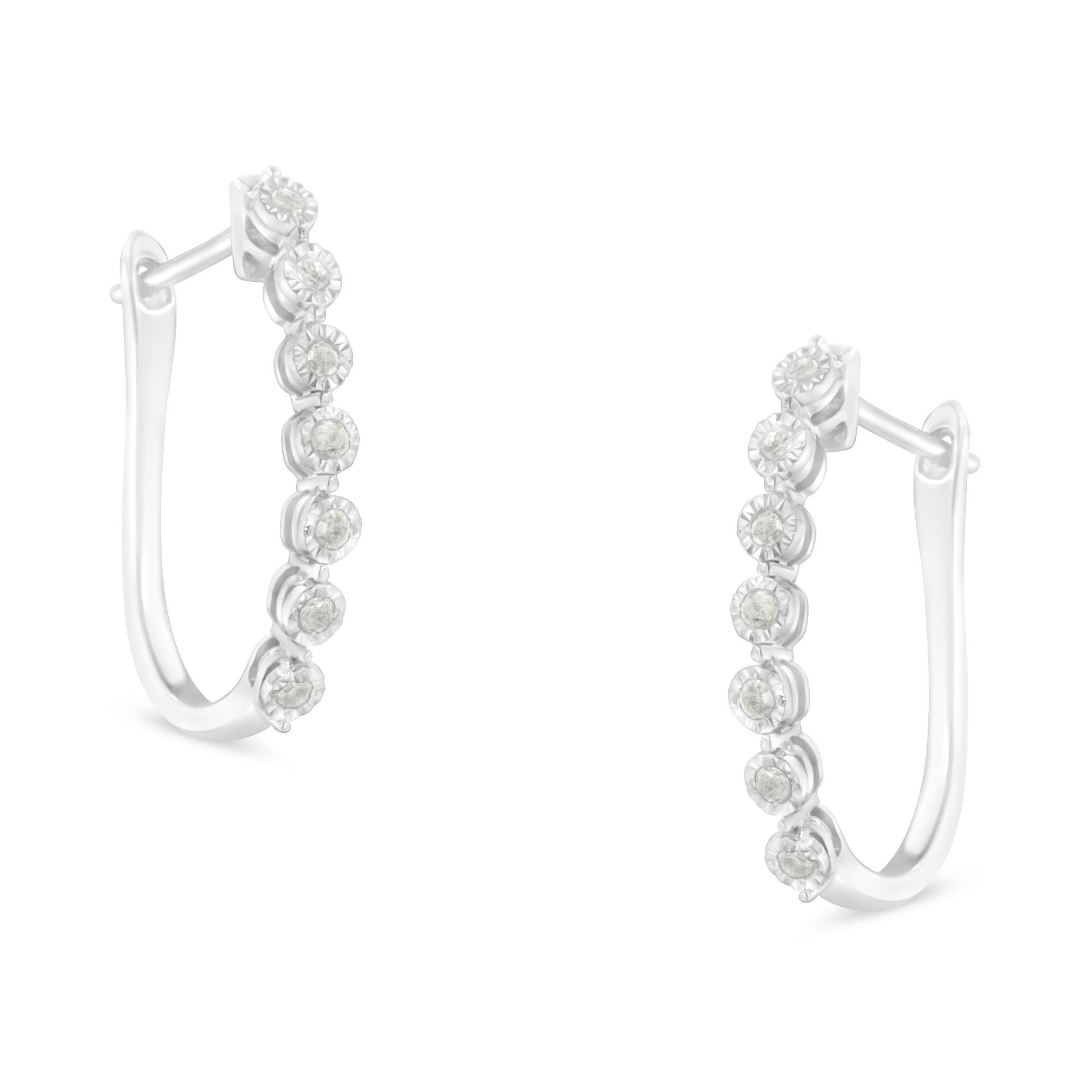 Pair of white metal hoop earrings with round white gemstones in miracle setting, shown from front angle.