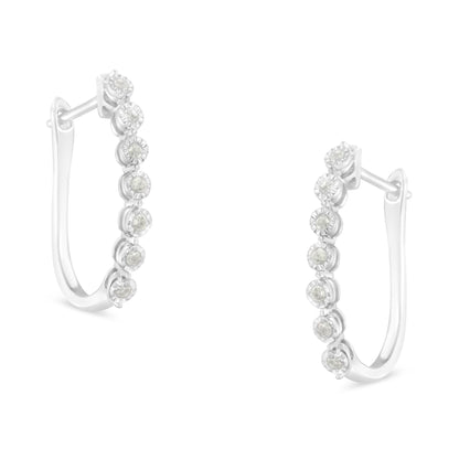Pair of white metal hoop earrings with round white gemstones in miracle setting, shown from front angle.
