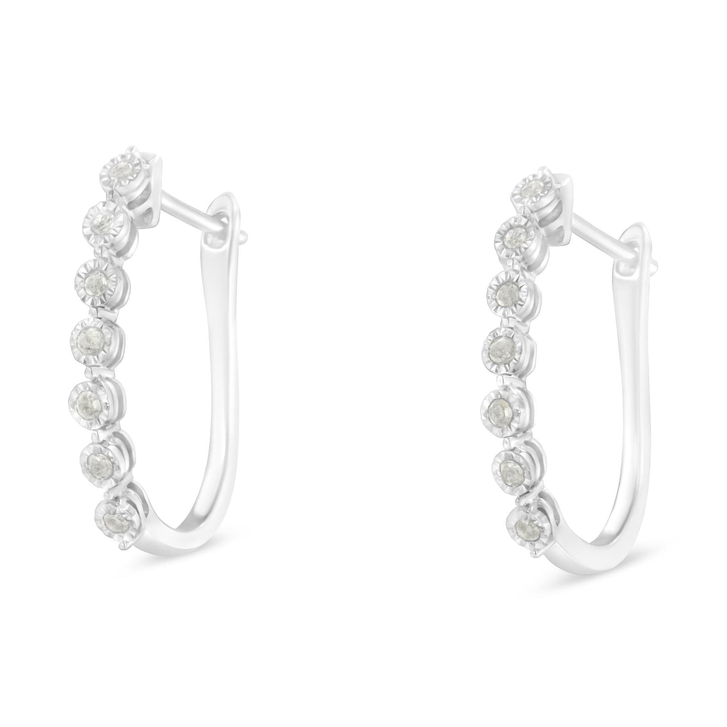 Pair of white metal hoop earrings with round white gemstones in a miracle setting, shown from a side angle.