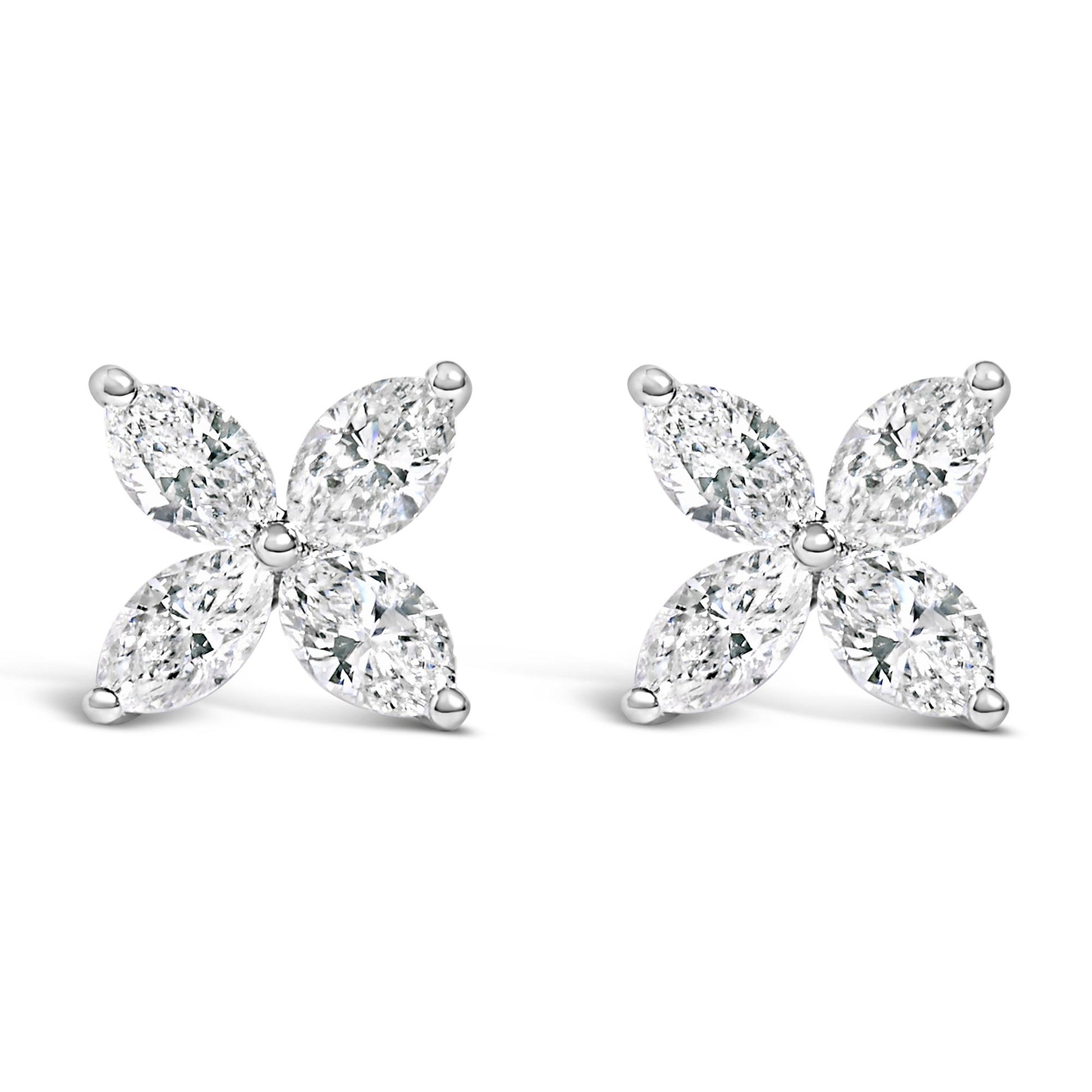 Pair of white metal earrings with four marquise-shaped white gemstones arranged in a floral pattern, front-facing angle.