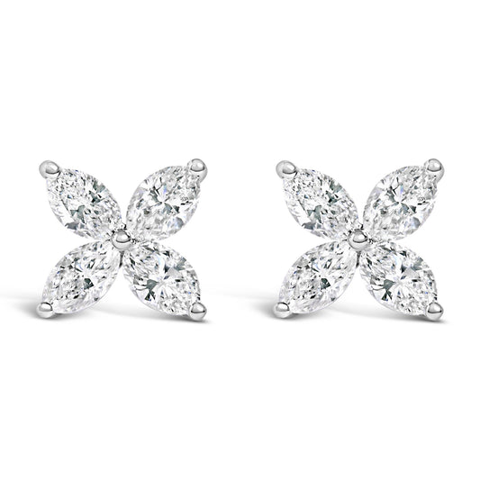 Pair of white metal earrings with four marquise-shaped white gemstones arranged in a floral pattern, front-facing angle.