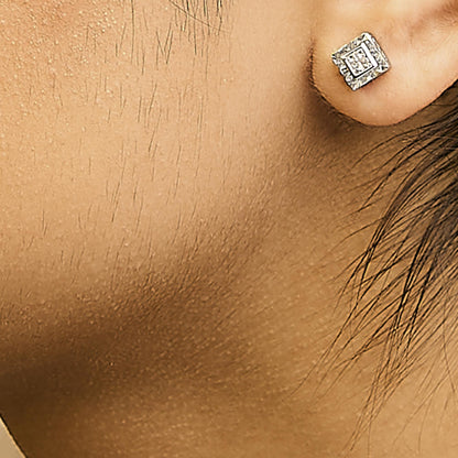 Close-up side view of a model wearing a white metal square stud earring with multiple small white gemstones in a princess shape and invisible setting.
