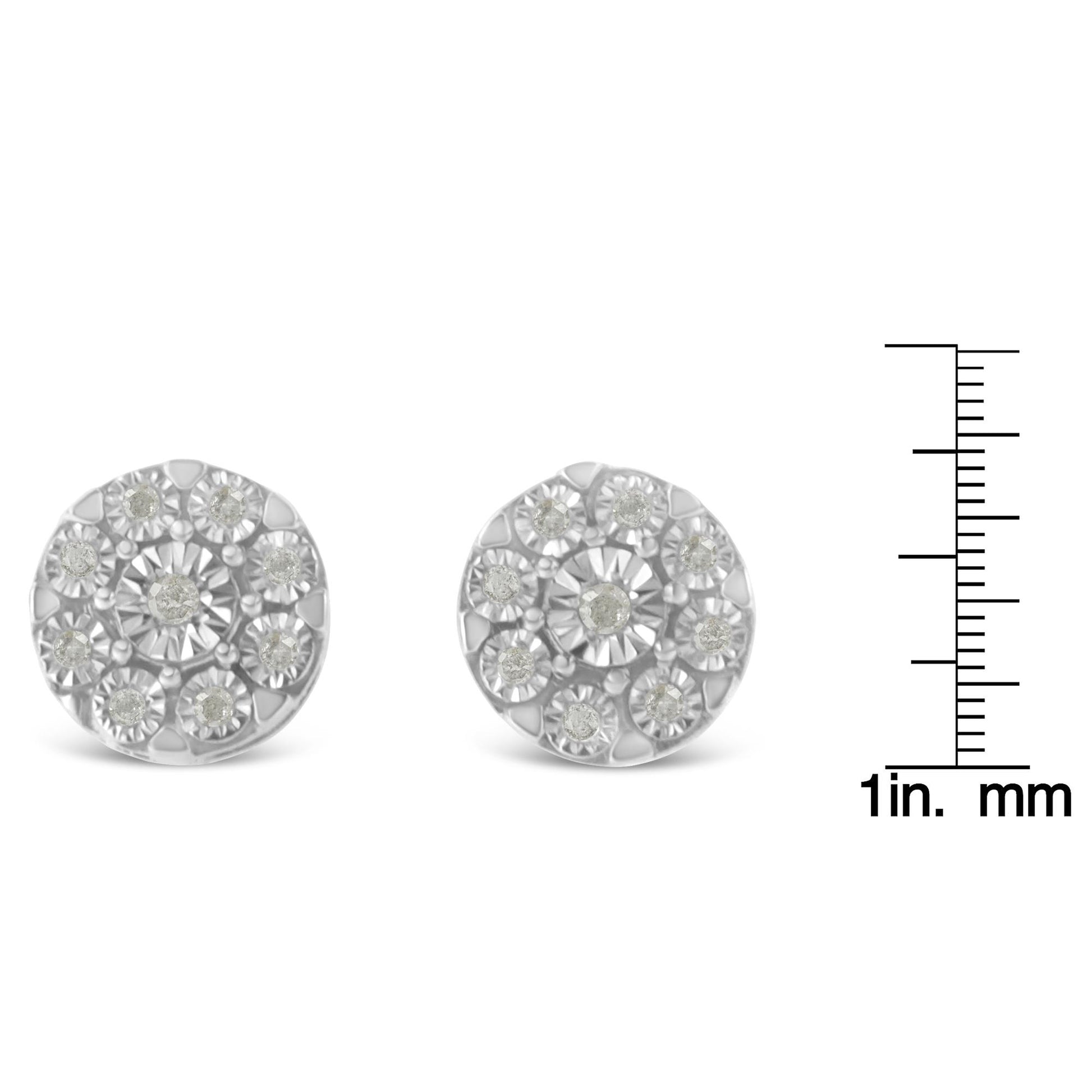 Front view of a pair of round white metal stud earrings with white gemstones, displayed next to a ruler for size reference.