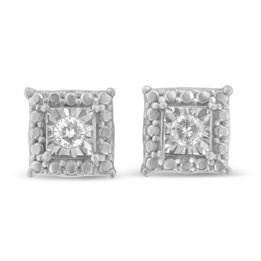 Front view of white metal square-shaped earrings with round white gemstones in the center and textured borders.