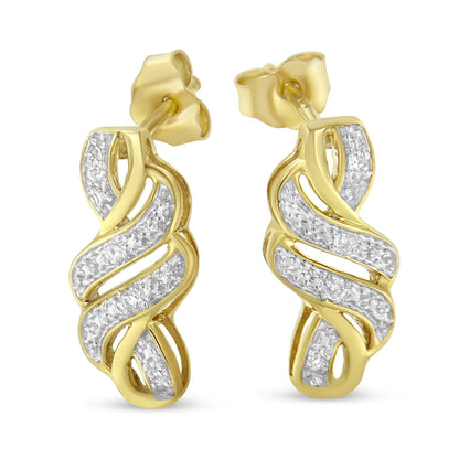 Close-up front angle of a pair of yellow and white metal twisted hoop earrings featuring pavé-set round white gemstones.