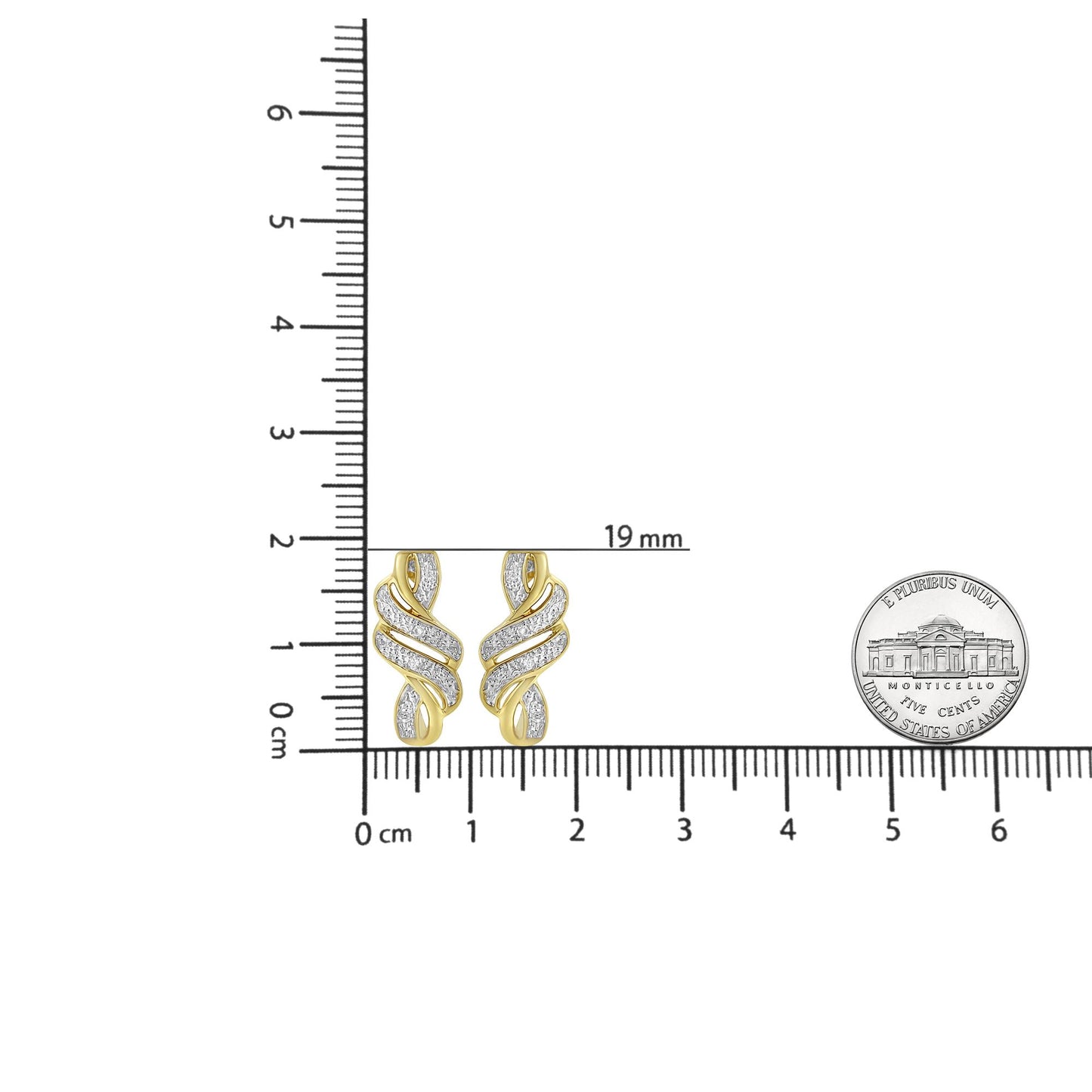 Pair of yellow and white metal earrings with pave set white round gemstones in a swirl design, shown from the front on a ruler and beside a coin for size reference.