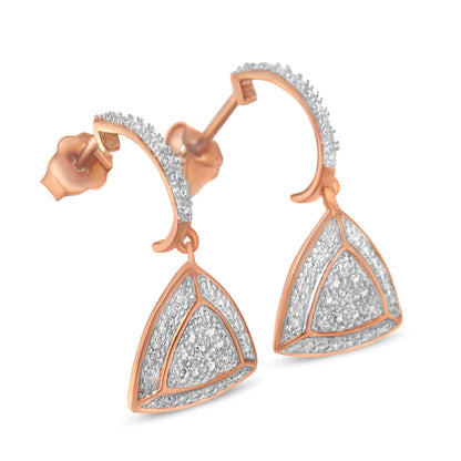 Close-up front angled view of rose metal triangular drop earrings with pave white gemstones on curved tops and triangle shapes.